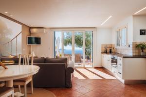 a living room with a couch and a table at The Infinity 180 Luxury Suites in Milia