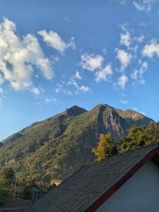 a mountain in the distance with a blue sky and clouds at Sunset Backpackers Hostel in Nongkhiaw +14 photos