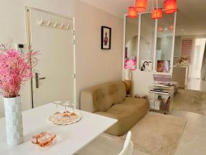 a living room with a couch and a table at "Rose" Atypique, clim, coeur du Quartier Haut in Sète +10 photos