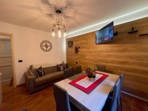 a living room with a table and a couch at Bormio 5 min - Casa Simona with Wifi and FreePark in Valdisotto