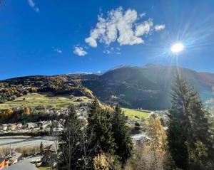 a view of a mountain with the sun in the sky at Bormio 5 min - Casa Simona with Wifi and FreePark in Valdisotto