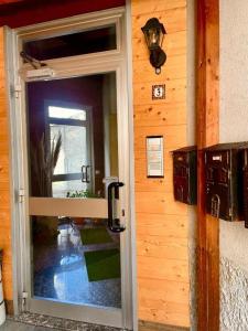 a door to a house with a glass doorway at Bormio 5 min - Casa Simona with Wifi and FreePark in Valdisotto