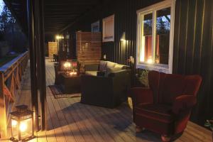 a porch with a chair and a patio at night at Vejbystrands Vandrarhem in Vejbystrand