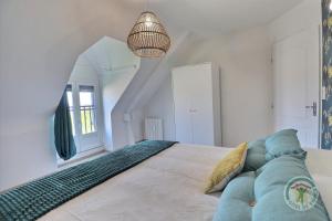 une chambre avec un grand lit et un canapé bleu dans l'établissement Cote rivage, à Cherrueix