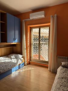 a room with two beds and a window at Da Chloe in Anagni