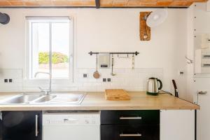a kitchen with a sink and a counter top at L'Atelier du Clos avec Jacuzzi in Puilboreau +43 photos