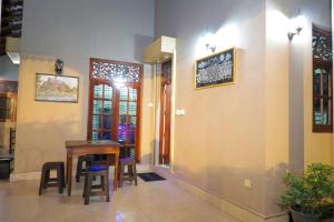 a room with a table and some chairs and a building at Shani Villa in Negombo +17 photos