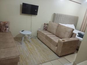 a living room with a couch and a table at DnC Homes in Nairobi