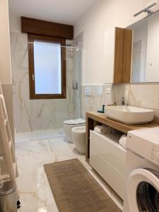 a bathroom with a sink and a toilet and a shower at Casa da Luigina 2 in Chioggia