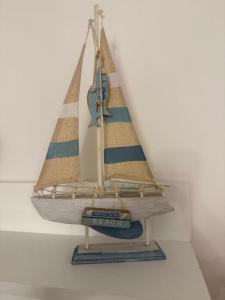 a wooden toy sailboat hanging on a wall at Casa da Luigina 2 in Chioggia
