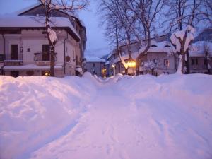 a pile of snow on the side of a street at B&B Dulcamara in Pescasseroli