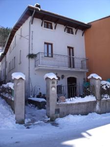 a white house with snow on the front of it at B&B Dulcamara in Pescasseroli