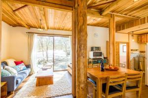 a living room with a table and a couch at Misorano Chalet in Hakuba