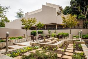 a garden in front of a building at Southern Sun Rosebank, Johannesburg in Johannesburg