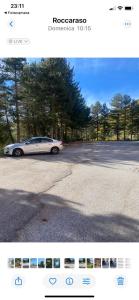 a picture of a white car driving down a street at Relax House in Roccaraso