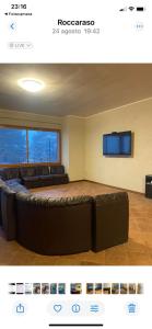 a living room with a couch and a flat screen tv at Relax House in Roccaraso +14 photos