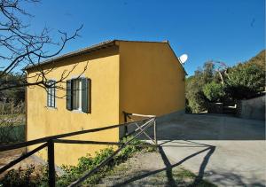 a small yellow building with a fence in front of it at Sansone Sul Mare Appartamenti in Portoferraio