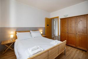 a bedroom with a large bed with two towels on it at Agriturismo La Corte dei Cavalieri in Montefalco +55 photos