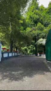 een parkeerplaats met bomen op de achtergrond bij 2 Bedroom villa in Mūvattupula