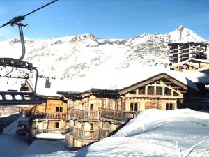 a ski lodge in the snow with a ski lift at Chalet Le Cordava in Tignes