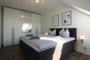 Postel nebo postele na pokoji v ubytování DümmerDiva - exquisite Wohnung mit traumhaftem Seeblick