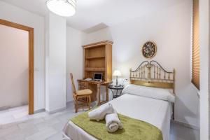 a bedroom with two beds and a desk with a computer at Inspiration and Comfort near Pts and Fermasa in Armilla +28 photos