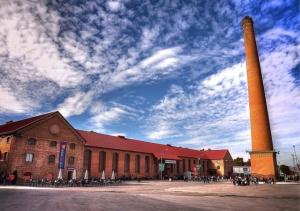 a large brick building with a tall tower in front of it at Inspiration and Comfort near Pts and Fermasa in Armilla