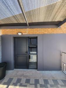 a door to a building with a roof at HomeAway Vredenburg in Vredenburg