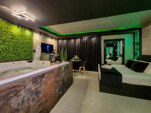 a bathroom with a tub and a bedroom with a bed at Florence Motel Spa - Santa Rosa-RS in Santa Rosa +11 photos