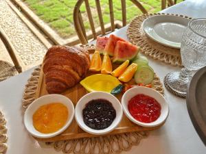 a tray of bread and fruit on a table at Villa Aniani in El Nido