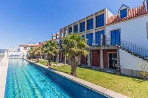 a swimming pool in front of a building at Santa Tecla - Safira in Caminha