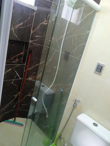 a shower with a glass door in a bathroom at Condomínio tropicaliente in Caucaia +3 photos
