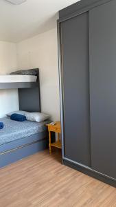 a bedroom with a bed and a sliding glass door at Apartamento Pé na Areia Barra Velha in Barra Velha +23 photos