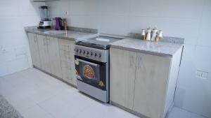a kitchen with an oven with a pizza in it at My Dream Apartments - 4 miles from Bole International Airport in Addis Ababa