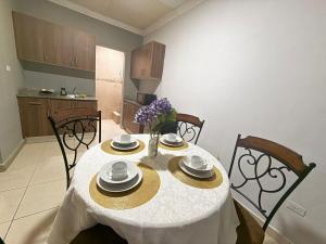 a dining room table with a white table cloth and chairs at Apartamentos Marconela in San Mateo