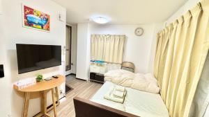 a living room with a couch and a table at Good One Awaji Accessia 401 in Osaka