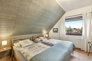 a bedroom with two beds and a window at Ferienwohnung Am Orpeturm in Marsberg
