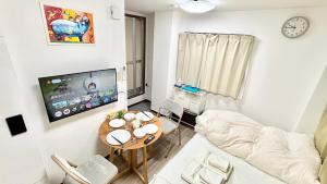 a living room with a couch and a table at Good One Awaji Accessia 401 in Osaka +9 photos