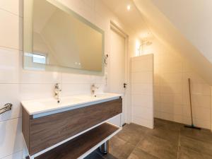 a bathroom with a sink and a mirror at Serene Holiday Home in De Koog Texel with Sauna in Westermient
