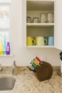 a kitchen counter with a bowl of toothbrushes at Family Holiday Retreat is Here- Yard, Fire Pit, Cloudy Beds, SoCO Eats and Shop in Austin +42 photos