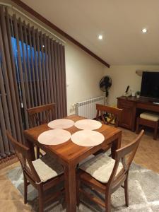 une salle à manger avec une table et des chaises en bois dans l'établissement St Ivan Rilski Free SPA Luxury Apartment Bansko, à Bansko