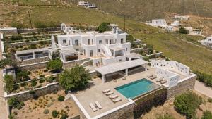 an aerial view of a large white house with a swimming pool at Bohemian Blue Villa - 7 BDRM - beach in 200m - MG Villas in Mykonos