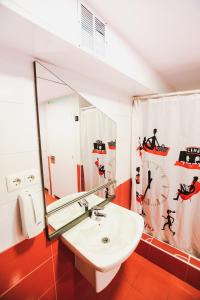a bathroom with a sink and a mirror at Latas Surf House in Somo +48 photos