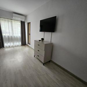 an empty room with a dresser with a television on it at Lovely apartment in Craiova