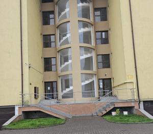 an empty building with a staircase in front of it at Lovely apartment in Craiova