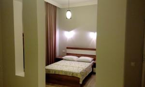 a small bedroom with a bed with two pillows at Old Street Guesthouse in Batumi