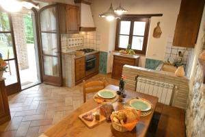 a kitchen with a table with food on it at Historic Farmhouse In The Tuscan Hills in Caprese Michelangelo