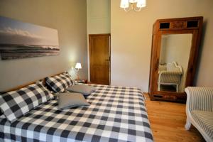 a bedroom with a black and white checkered bed at Historic Farmhouse In The Tuscan Hills in Caprese Michelangelo