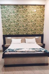 Ένα ή περισσότερα κρεβάτια σε δωμάτιο στο Hotel Sundaram