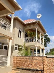 a house with a balcony and a satellite at KIGALI DYNAMICs HOMES AND HOTEL in Kigali